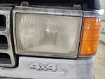 Driver Left Headlight With Chrome Trim Fits 87-91 Ford F150 Pickup 1342150. Fixed Price $40.00.