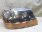 Passenger Rt Headlight Smoke Tint Dark Background Fits 99-02 Jeep Grand Cherokee. Fixed Price $39.00.