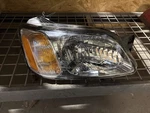 Passenger Headlight Without Black Horizontal Bar Fits 00-04 Legacy 1438452. Fixed Price $94.50.
