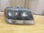 Passenger Headlight Smoke Tint Dark Background Fits 99-02 Grand Cherokee 180041. Fixed Price $42.00.