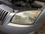 Driver Left Headlight Halogen Thru 2/19/06 Fits Milan 770898. Fixed Price $120.00.